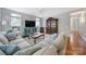 Spacious living room with hardwood floors, large windows, and plush sofa at 918 Kite Dr, Fort Mill, SC 29715