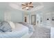 A bright main bedroom with a tray ceiling, soft carpet, and an en-suite bathroom and walk-in closet at 918 Kite Dr, Fort Mill, SC 29715