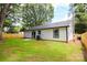 The backyard boasts a charming patio, lush lawn, and a newly installed fence at 9208 Detroiter Dr, Huntersville, NC 28078