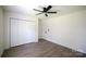 This bedroom features a ceiling fan and large closet for plenty of storage at 9208 Detroiter Dr, Huntersville, NC 28078