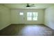 Bright and airy living room featuring sleek flooring and modern ceiling fan at 9208 Detroiter Dr, Huntersville, NC 28078