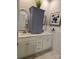 Bright bathroom with double sinks, a storage cabinet, modern fixtures and shower at 1224 Dali Blvd, Mount Holly, NC 28120