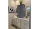 Bathroom featuring double sinks, a storage cabinet, and modern fixtures at 1224 Dali Blvd, Mount Holly, NC 28120