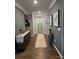 Inviting entryway with stylish console, decorative accents, modern artwork and beautiful wood flooring at 1224 Dali Blvd, Mount Holly, NC 28120