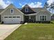 Charming single-story home features a well-maintained lawn and attached two-car garage at 1224 Dali Blvd, Mount Holly, NC 28120