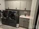 Functional laundry room equipped with modern washer/dryer, sink, and cabinetry at 1224 Dali Blvd, Mount Holly, NC 28120