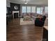 Comfortable living room with a cozy fireplace and a large sectional sofa for entertaining at 1224 Dali Blvd, Mount Holly, NC 28120