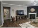 Living room featuring a fireplace, modern decor, and wood-look flooring at 1224 Dali Blvd, Mount Holly, NC 28120