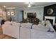 Cozy living room with a large sectional sofa, entertainment center, and natural light at 1224 Dali Blvd, Mount Holly, NC 28120