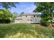 Picture of a home's spacious backyard featuring green grass and mature trees at 12325 Woodside Falls Rd, Pineville, NC 28134