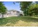 Spacious backyard offering green lawn, mature trees, and detached garage at 12325 Woodside Falls Rd, Pineville, NC 28134