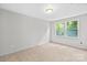 Bedroom featuring plush carpet, two windows, and ample space at 12325 Woodside Falls Rd, Pineville, NC 28134