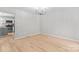 Bright dining room featuring hardwood floors and modern chandelier fixture at 12325 Woodside Falls Rd, Pineville, NC 28134