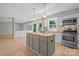 Open kitchen featuring wooden island, stainless steel appliances and white cabinetry at 12325 Woodside Falls Rd, Pineville, NC 28134