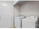 Bright laundry room equipped with washer, dryer and white door at 12325 Woodside Falls Rd, Pineville, NC 28134