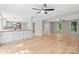 Spacious living room with hardwood flooring flows to the eat-in kitchen and front entry at 12325 Woodside Falls Rd, Pineville, NC 28134