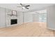 Spacious living room featuring wood floors, fireplace, and French doors at 12325 Woodside Falls Rd, Pineville, NC 28134