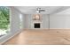 Bright living room with wood floors, fireplace, and plenty of natural light at 12325 Woodside Falls Rd, Pineville, NC 28134