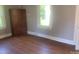 Simple bedroom featuring hardwood floors, a closet, and natural light from the window at 1242 Mitchell Ave, Statesville, NC 28677