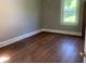 Inviting bedroom featuring gleaming hardwood floors and natural light from the window at 1242 Mitchell Ave, Statesville, NC 28677