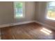 Bright bedroom with hardwood floors, two windows, and neutral walls at 1242 Mitchell Ave, Statesville, NC 28677