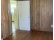 Bedroom features wood-paneled walls and hardwood floors at 1242 Mitchell Ave, Statesville, NC 28677
