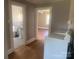 Functional laundry area leading to a well-lit bathroom and bedroom at 1242 Mitchell Ave, Statesville, NC 28677