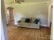 Inviting living room featuring hardwood floors and a plush sofa with decorative pillows at 1242 Mitchell Ave, Statesville, NC 28677