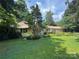 Well-maintained single-story home with lush greenery, garden, and manicured lawn at 126 Aqua Dr, Mooresville, NC 28117