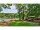Scenic lake view with colorful kayaks on the grassy shore, with green trees in the background at 126 Aqua Dr, Mooresville, NC 28117