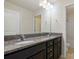 Bathroom with granite countertops, dual sinks, and a large mirror at 12704 Franklin Square Rd, Charlotte, NC 28213