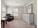 Bright bedroom with carpet floors, plenty of natural light and a dresser with mirror at 12704 Franklin Square Rd, Charlotte, NC 28213