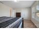 Bedroom featuring a wooden bed frame, carpet, and natural light from windows at 12704 Franklin Square Rd, Charlotte, NC 28213