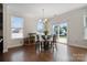 Bright dining area with a glass table, backyard views through sliding glass doors, and modern lighting at 12704 Franklin Square Rd, Charlotte, NC 28213