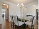 Dining room featuring hardwood floors, a glass table with six chairs, and neutral paint at 12704 Franklin Square Rd, Charlotte, NC 28213