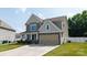 Beautiful two-story home with well-maintained landscaping, a two-car garage, and a concrete driveway at 12704 Franklin Square Rd, Charlotte, NC 28213