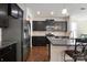 Kitchen with dark cabinets, stainless steel appliances, granite countertops, and hardwood floors at 12704 Franklin Square Rd, Charlotte, NC 28213