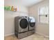 Well-lit laundry room with modern washer and dryer units and shelving at 12704 Franklin Square Rd, Charlotte, NC 28213