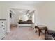 The main bedroom boasts a large bed, tray ceiling, and ensuite bathroom at 12704 Franklin Square Rd, Charlotte, NC 28213