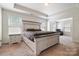 Spacious main bedroom with a tray ceiling, large bed and attached sitting area at 12704 Franklin Square Rd, Charlotte, NC 28213
