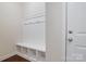 Mudroom with built in bench and cubbies next to a white door at 12704 Franklin Square Rd, Charlotte, NC 28213