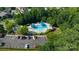 Aerial shot of a community pool with shaded seating, a separate kiddie pool, and ample parking at 12704 Franklin Square Rd, Charlotte, NC 28213