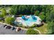 A vibrant community pool area featuring sun umbrellas and comfortable lounge chairs, offering a refreshing retreat at 12704 Franklin Square Rd, Charlotte, NC 28213