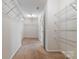 Large walk-in closet featuring wire shelving, carpet floors, and access to attic space at 12704 Franklin Square Rd, Charlotte, NC 28213