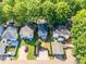 Aerial view of a home with a backyard, covered patio, and fenced-in yard in a tree-lined neighborhood at 13115 Meadowmere Rd, Huntersville, NC 28078