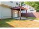 View of the home's backyard featuring a covered patio and lush grassy areas at 13115 Meadowmere Rd, Huntersville, NC 28078