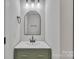 Stylish bathroom featuring a modern vanity, matte black fixtures, and sleek mirror at 13115 Meadowmere Rd, Huntersville, NC 28078