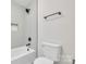 Bathroom with combination tub and shower, neutral tones and tile surround at 13115 Meadowmere Rd, Huntersville, NC 28078