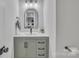 Bathroom vanity with decorative mirror, modern sink, and neutral tones at 13115 Meadowmere Rd, Huntersville, NC 28078