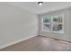 Bright bedroom featuring light wood flooring and an abundance of natural light from the dual windows at 13115 Meadowmere Rd, Huntersville, NC 28078
